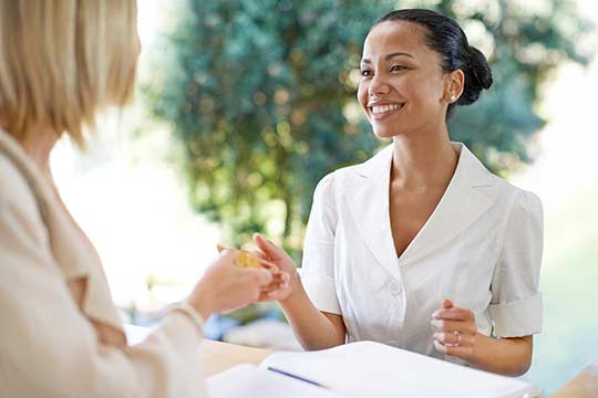 A receptionist accepting payment for hearing aids. 